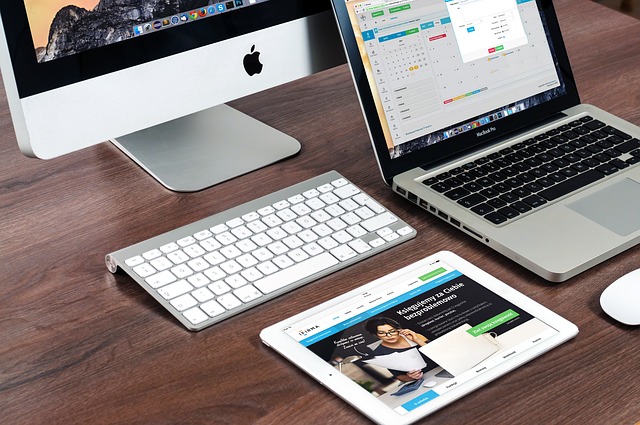 several apple computers on a desk