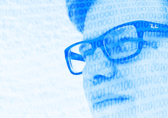 a man in glasses with binary code superimposed